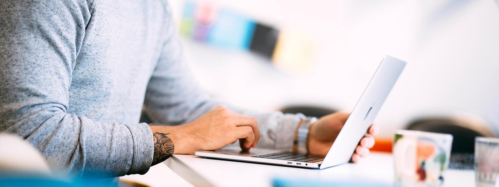 Close-up view of a man with laptop