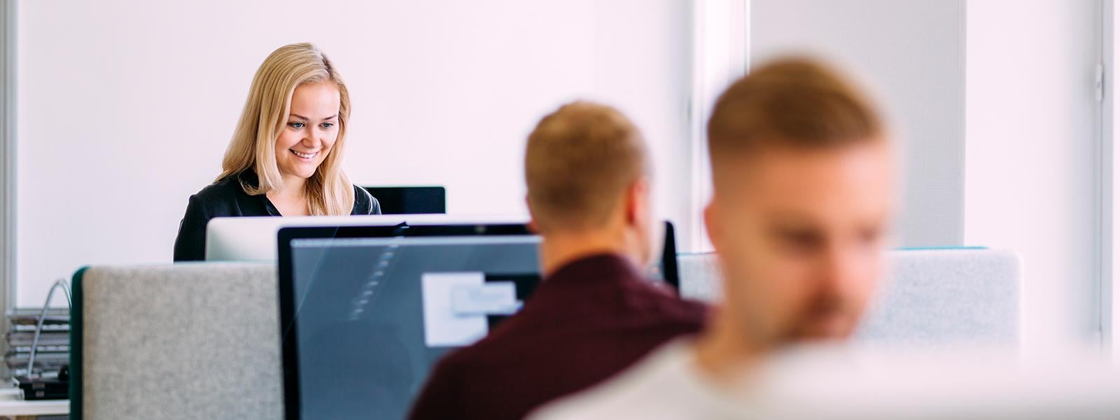 Three people working opposite each other at the office