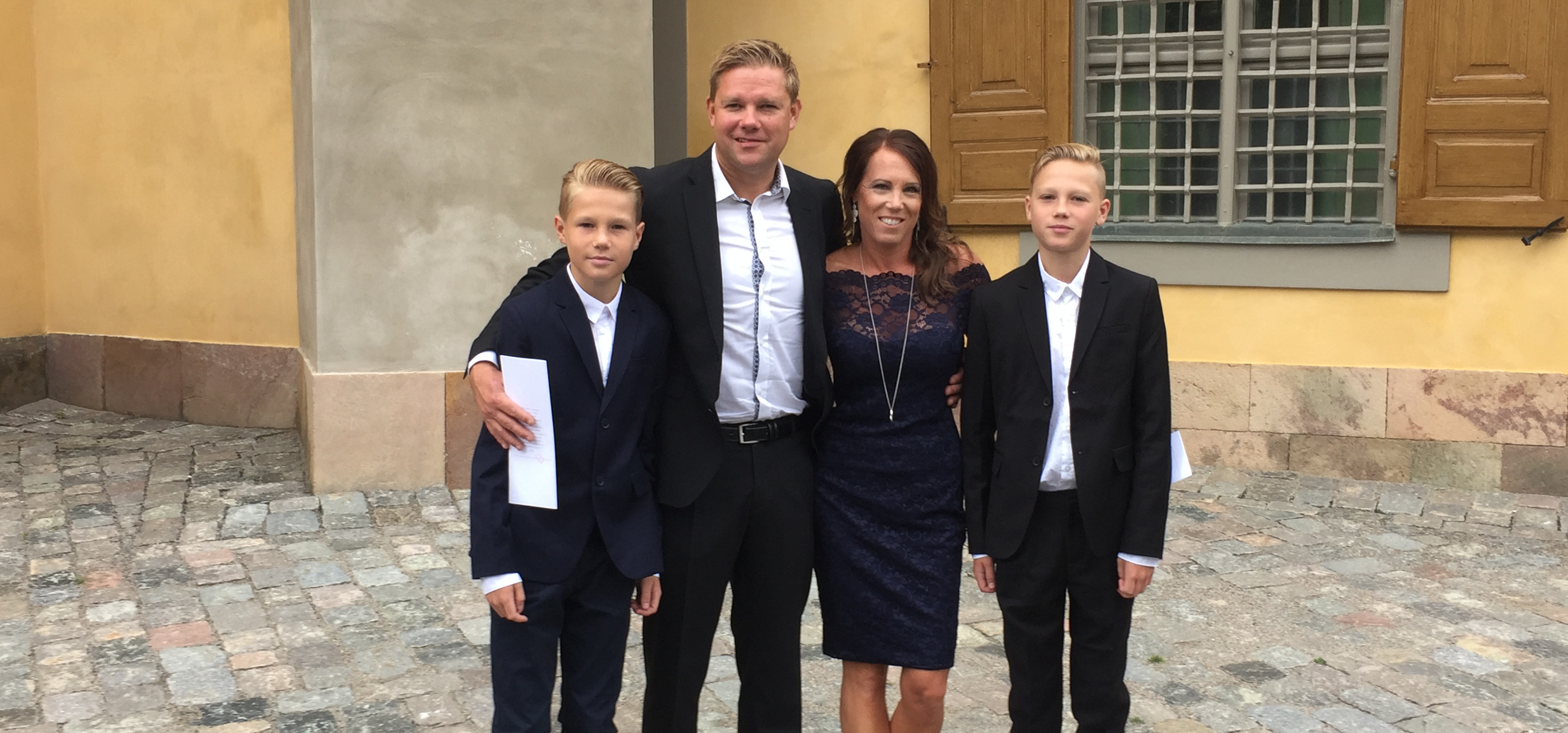 Four people posing in formal clothes