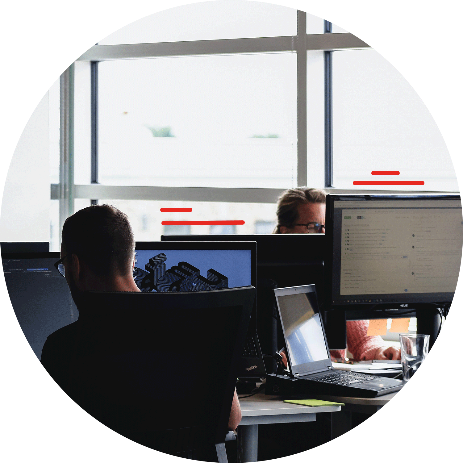 Two people focusing on working in front of computer screens