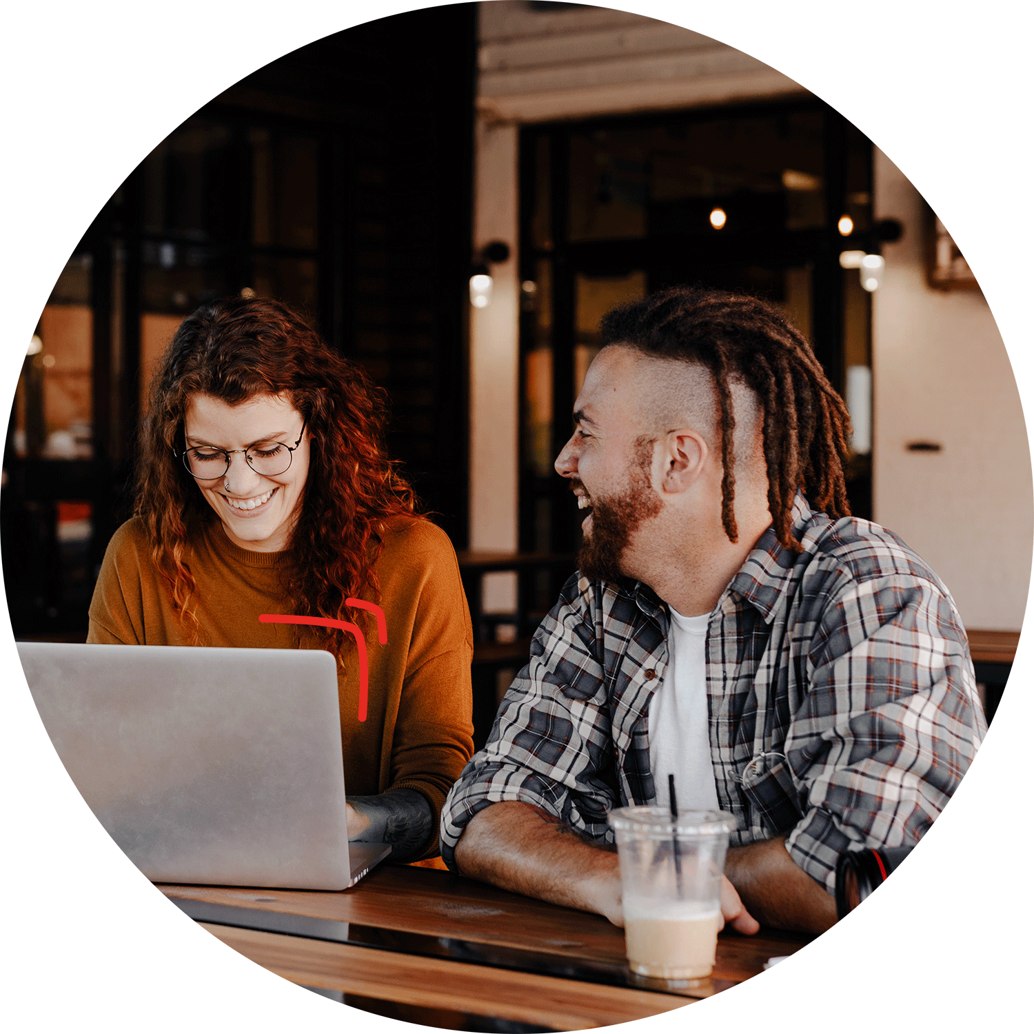 Two people working together in front of a computer