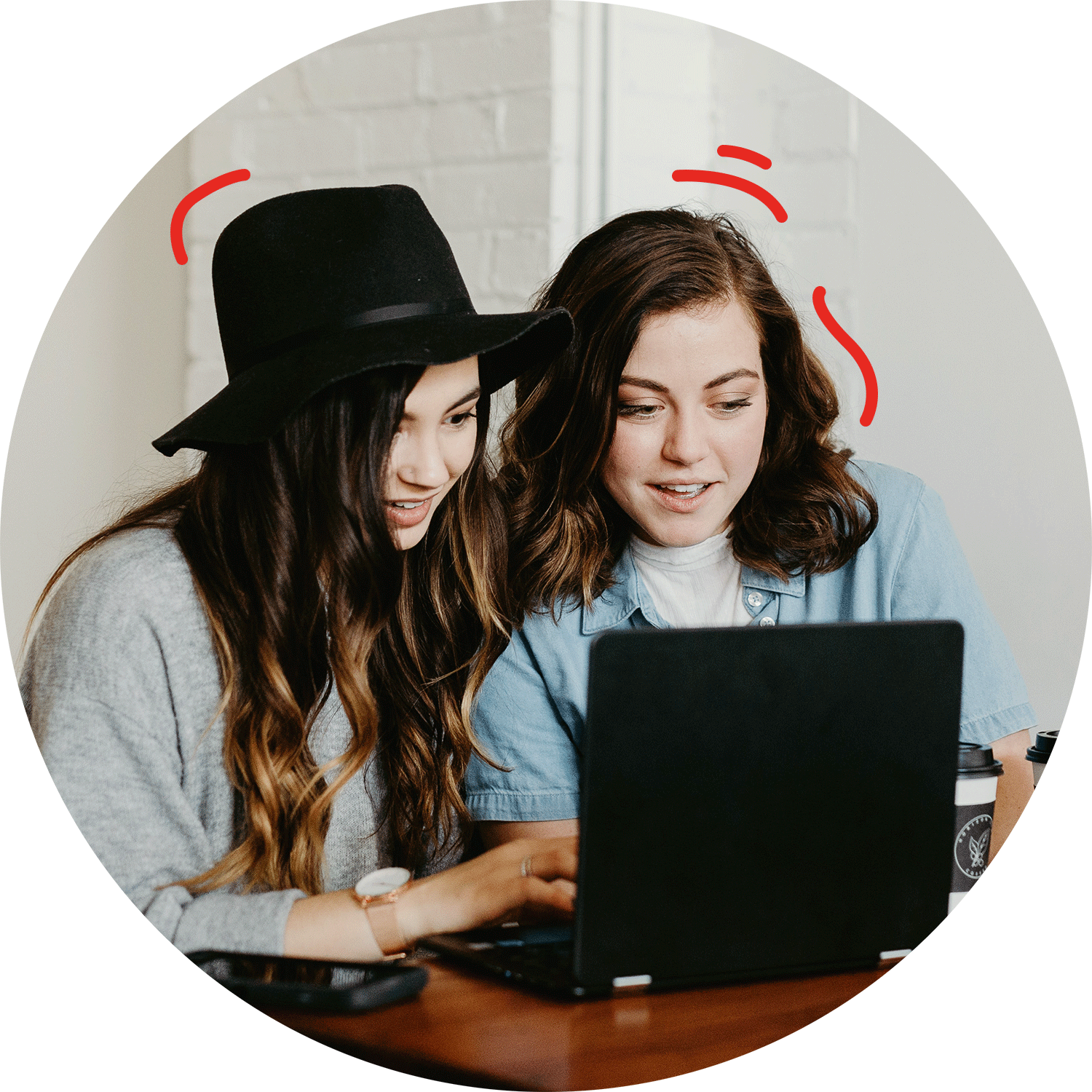 two peope working in front of one computer